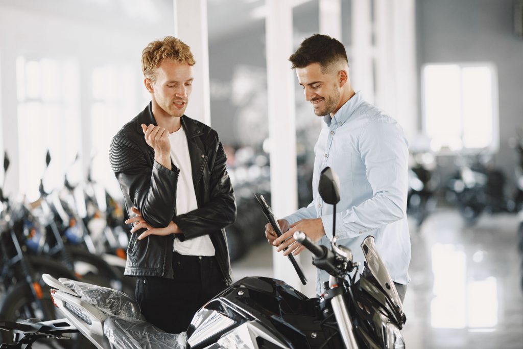 Il venditore illustra al clienti i vantaggi dell'acquisto di una moto o di uno scooter in leasing